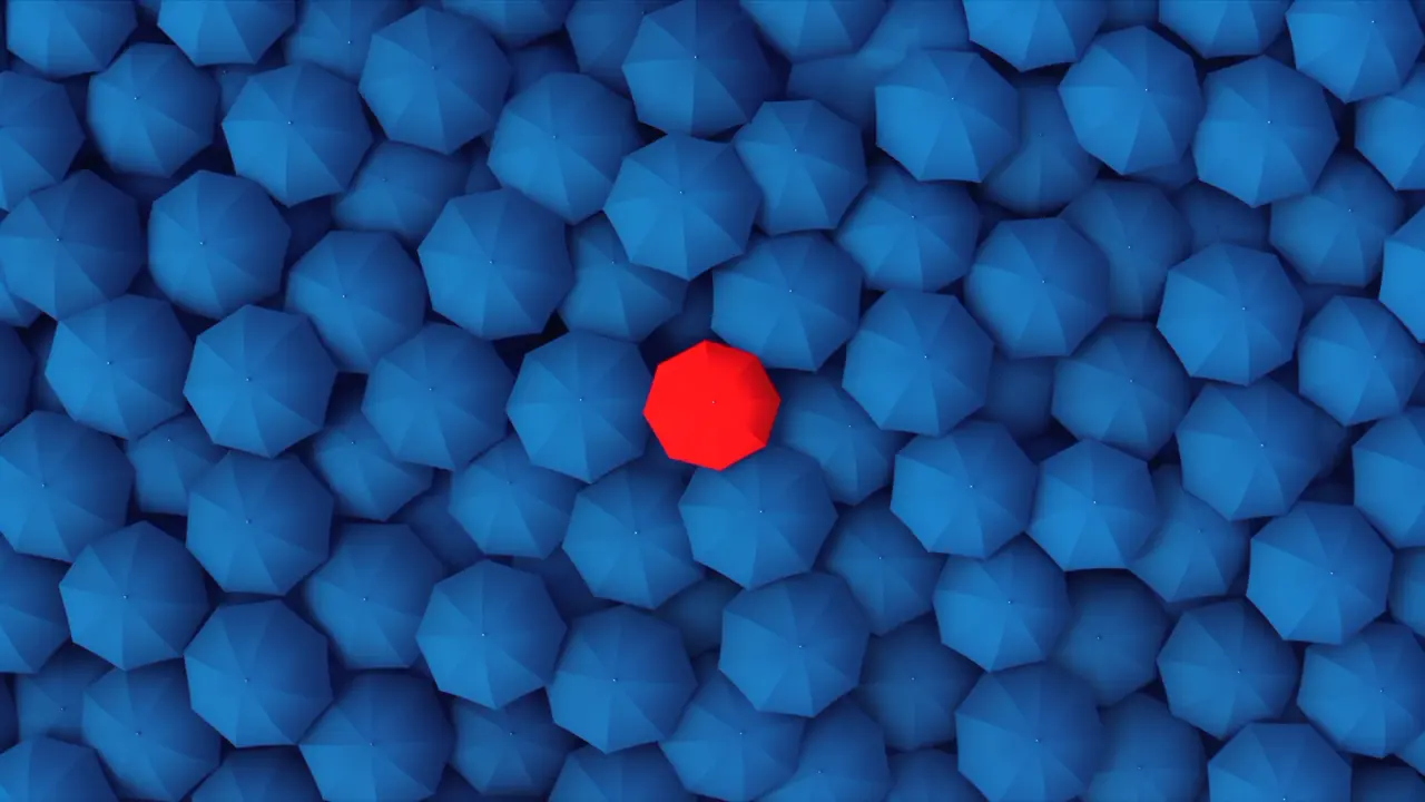 One red umbrella in a sea of blue